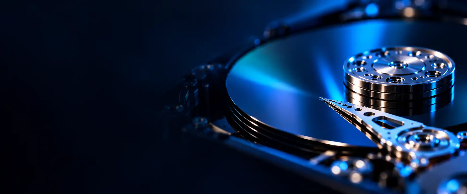 Close-up of a hard drive platter and actuator arm — professional hard drive data recovery in Borivali